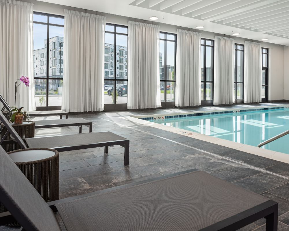 Slate resident indoor pool amenity with lounge chairs.