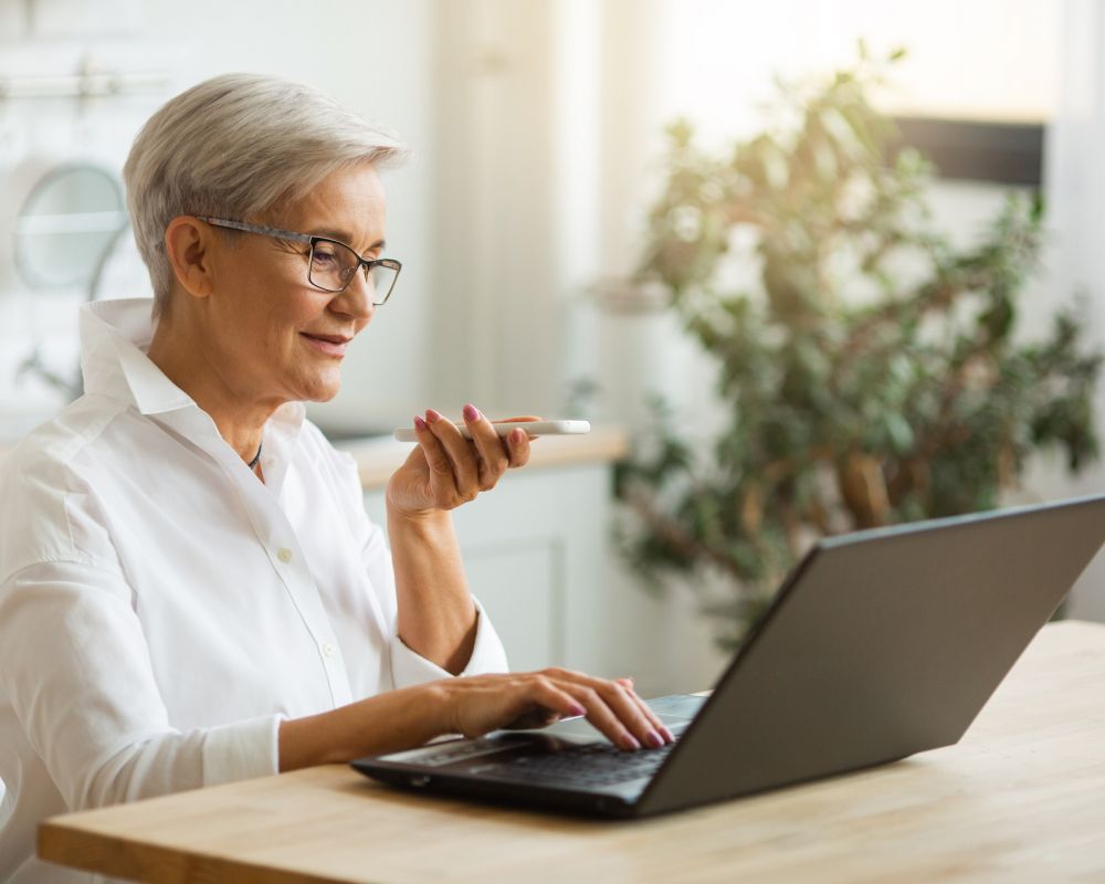 Senior woman paying apartment utility bill on laptop