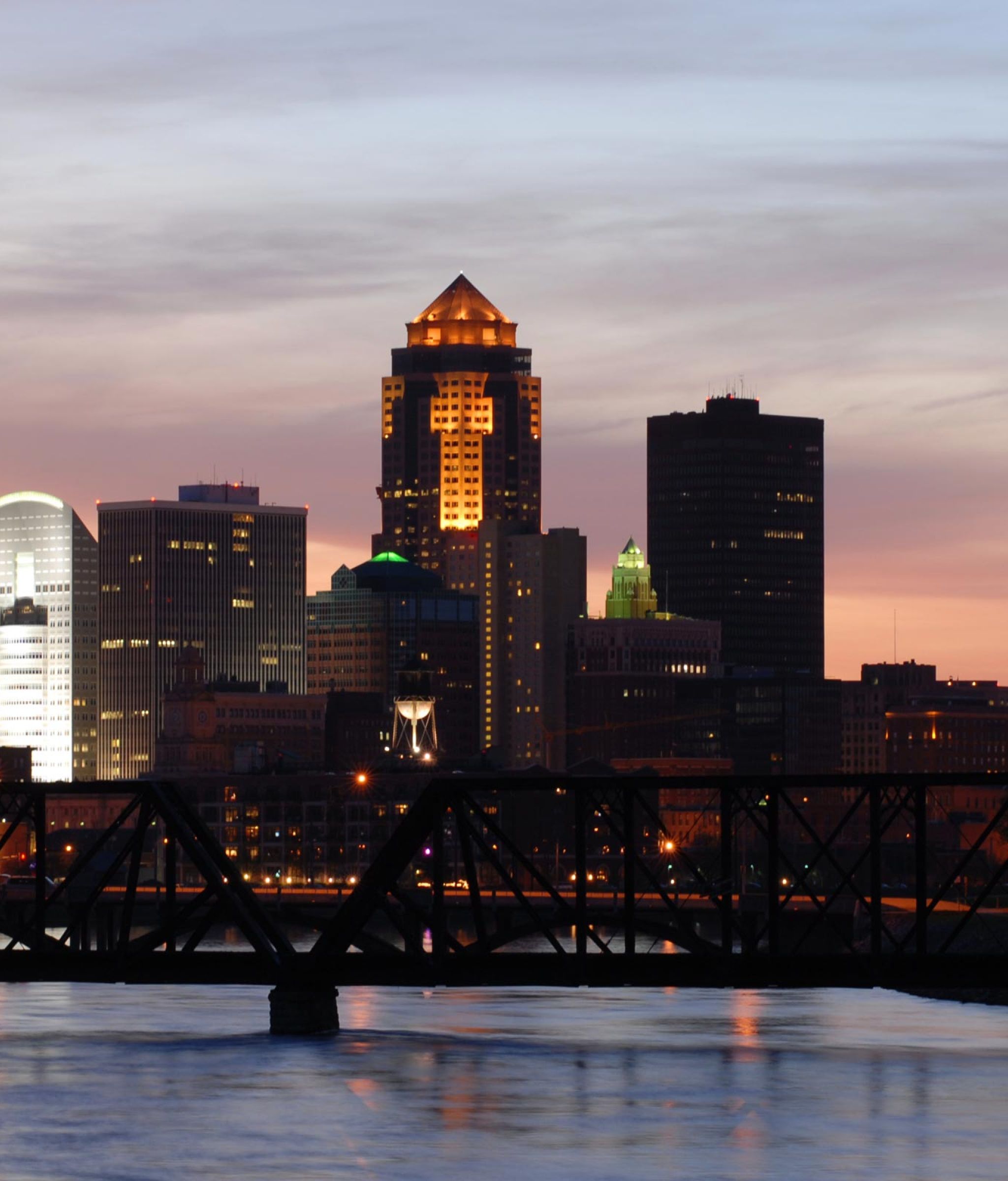 Des Moines Iowa skyline at evening overlooking the water and tall buildings