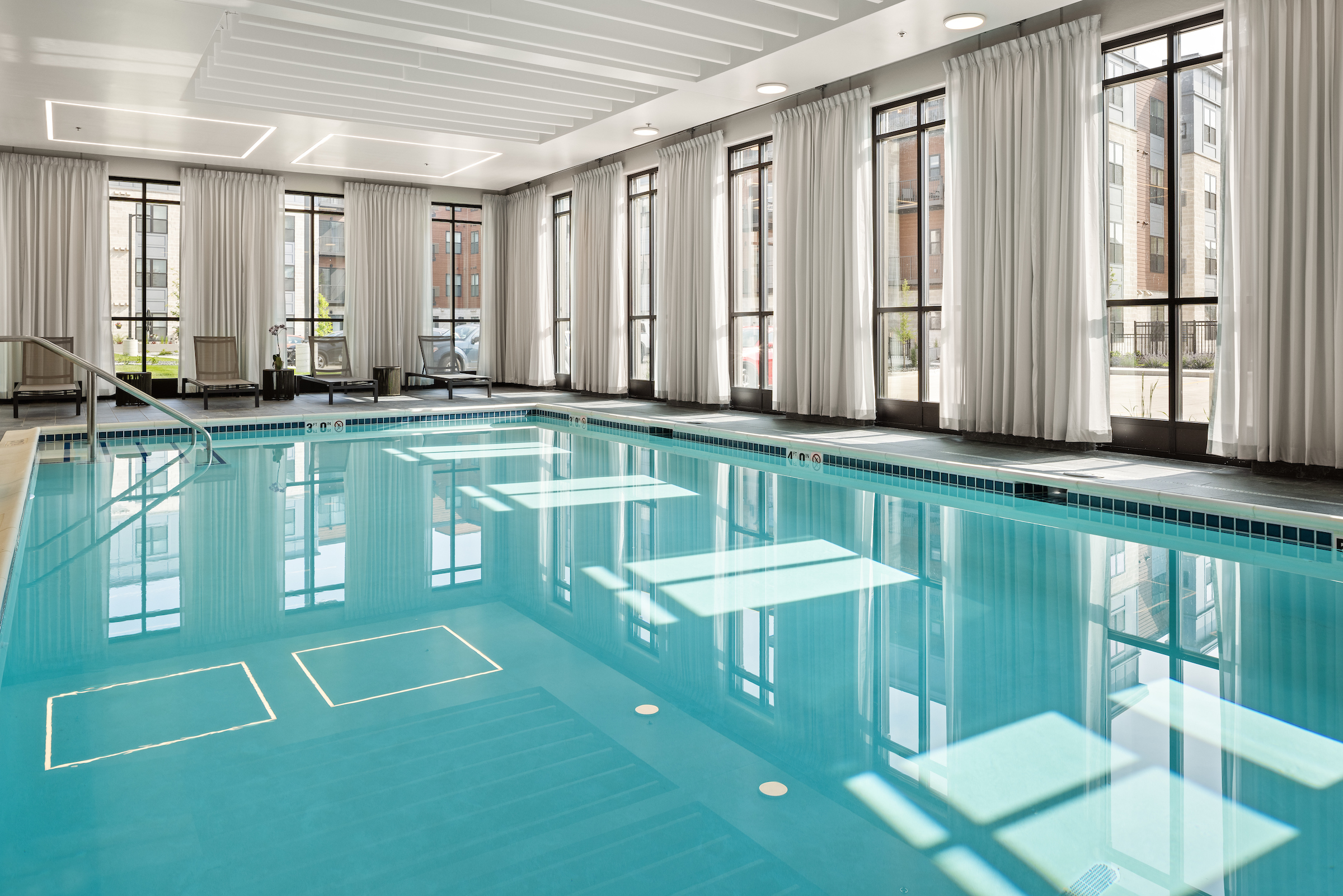 Slate large indoor pool with large windows.