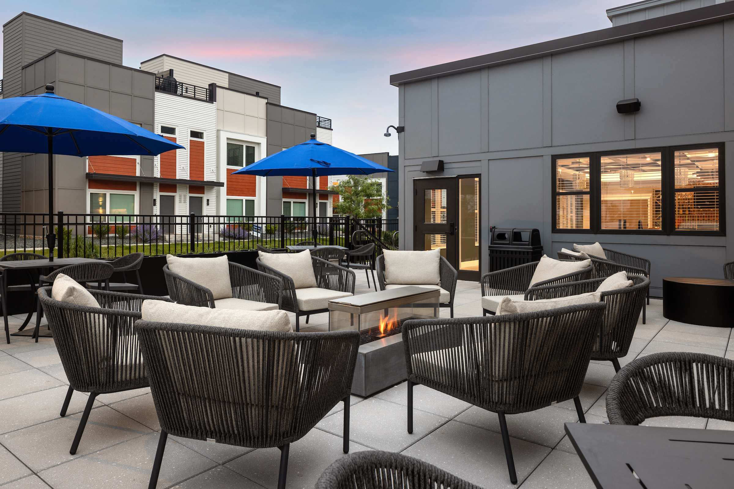 Slate apartments outdoor deck area with plush furniture.