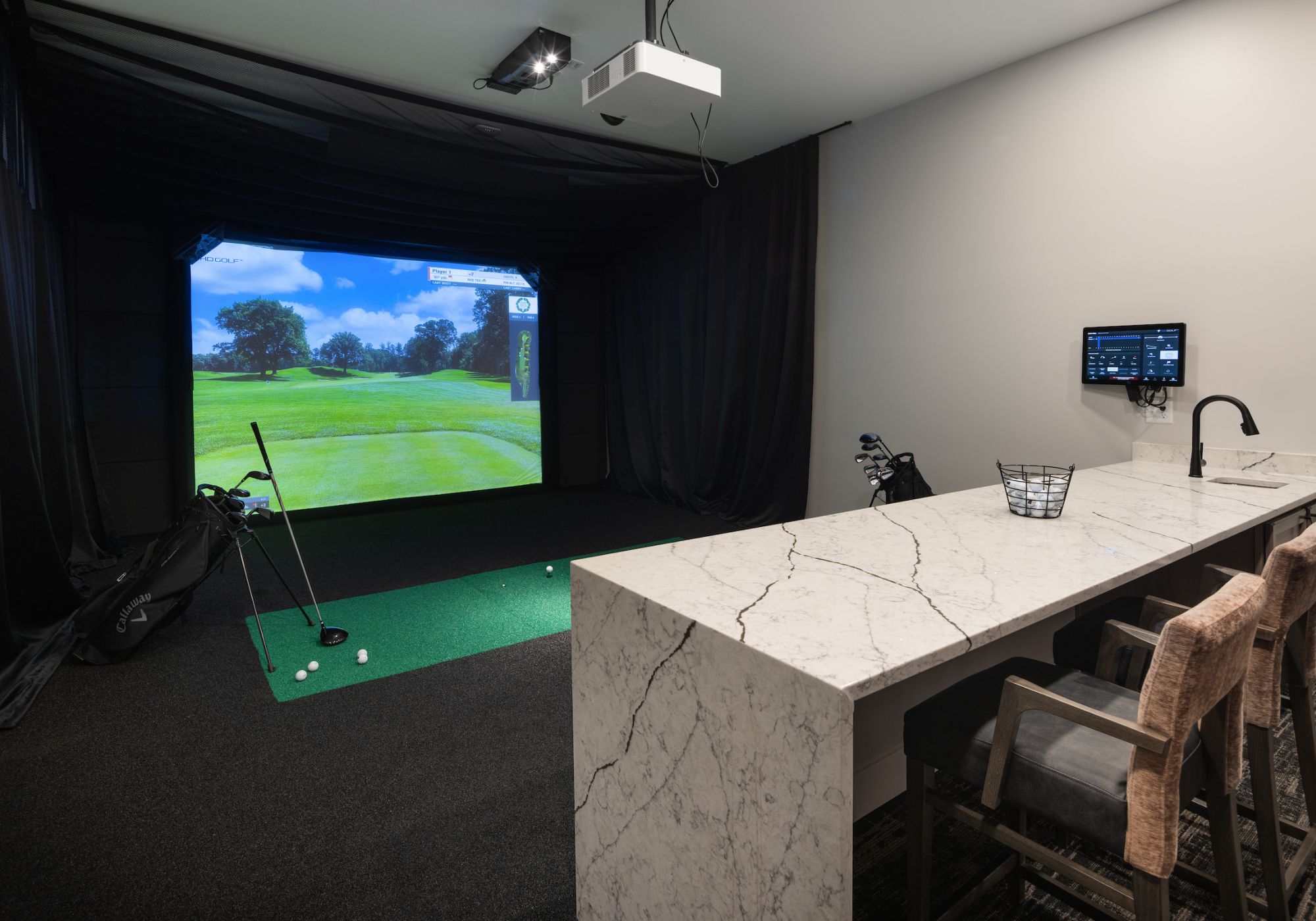 Slate apartments resident virtual golf room amenity.